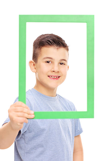 istock Cute little boy posing behind a picture frame 468818790