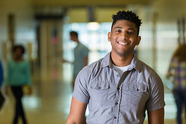 istock Happy African American high school student smiling, walking in hallway. 468822682
