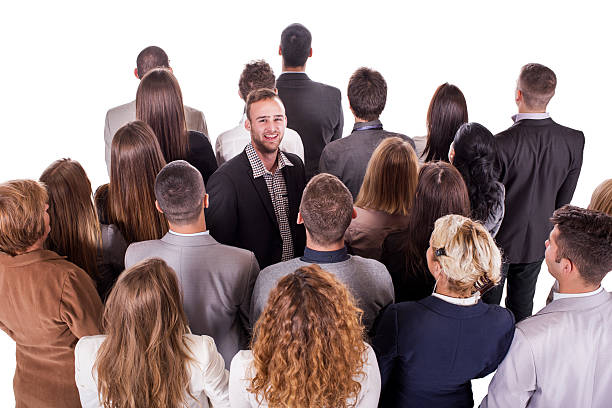 istock Young businessman standing opposite from his colleagues. Isolated on white. 468823044