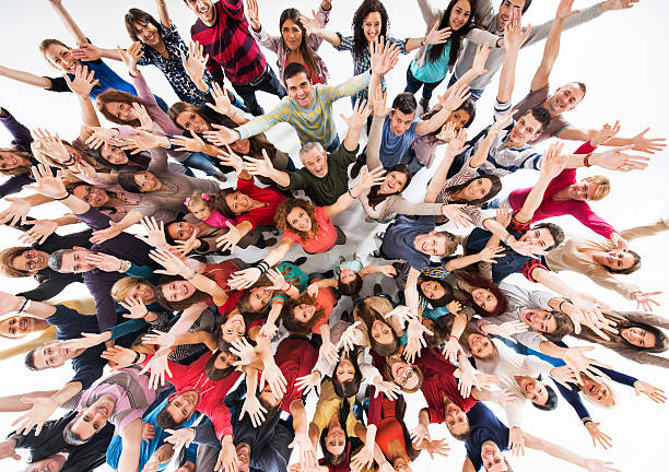 istock High angle view of crowd of people with raised hands. 468823078