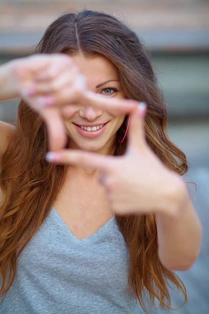 istock Closeup of young beautiful woman making frame with her hands 468824509