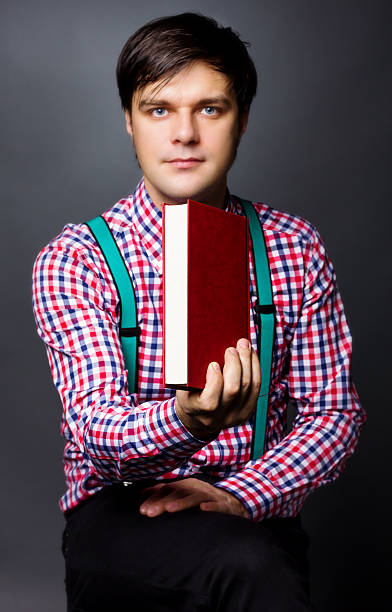 istock Portrait of handsome young man holding a book 468824953