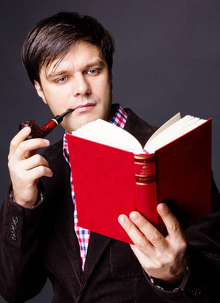 istock Portrait of man smoking a pipe while reading 468824973