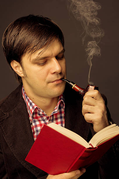 istock Portrait of man reading and smoking a pipe 468824989