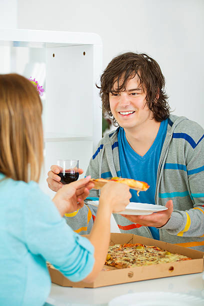 istock Cheerful Young Couple Eating Pizza. 468825097