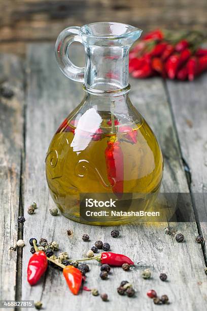 Olive Oil With Chili Peppers Stock Photo - Download Image Now - Backgrounds, Bottle, Bright