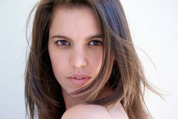 Close up portrait of a beautiful girl posing on white background