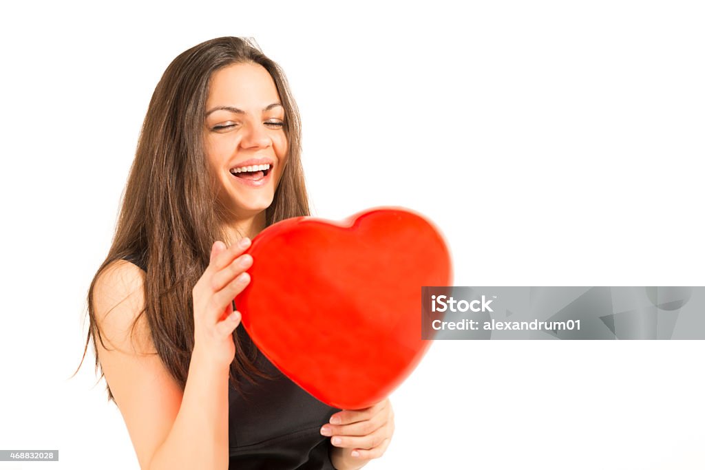 Woman holding red heart balloon Love and valentines day. woman holding heart balloon smiling, cute and adorable isolated on white background. Woman with red heart balloon on a white background.  2015 Stock Photo