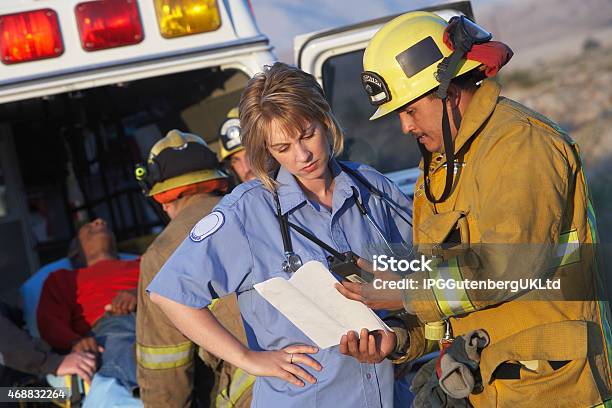 Fire Fighters And Paramedics Stock Photo - Download Image Now - Paramedic, Firefighter, Doctor