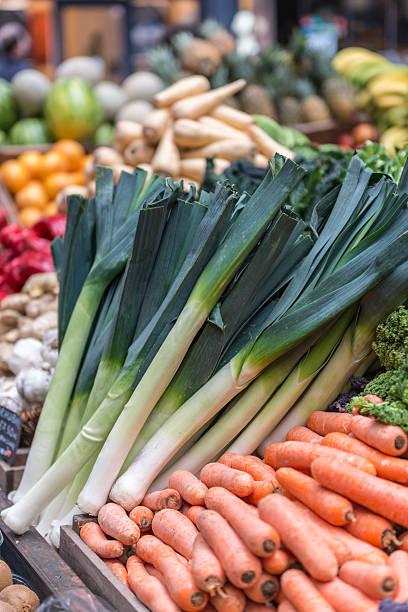 istock Fresh leeks and carrots displayed on a vegetable stall 468832360