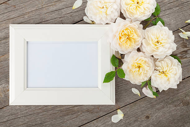 istock Blank photo frame and white roses 468832422