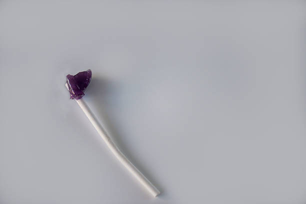 detail of lolly chewed purple, on the white background