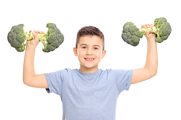 istock Little kid holding two broccoli dumbbells 468833302