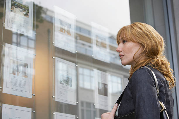 istock Woman Looking Real Estate Office Display 468833564