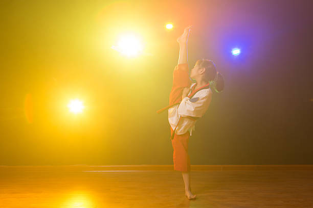 The little girl is practising Taekwondo.