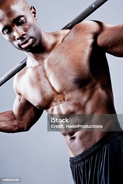 Bodybuilder Posing With Weight Bar Stock Photo - Download Image Now - 2015, 25-29 Years, Abdominal Muscle