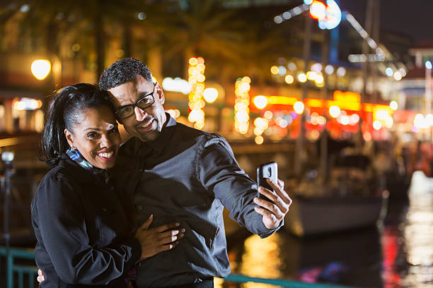 istock Mature black couple out on date at night taking selfie 468836486