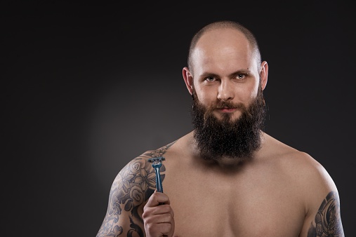 Muscular Bald Man With A Beard Holding A Razor Stock Photo - Download Image  Now - Men, Shaving, Only Men - iStock