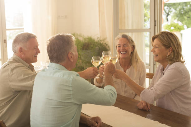 istock Senior couples toasting wine glasses at table 468837479
