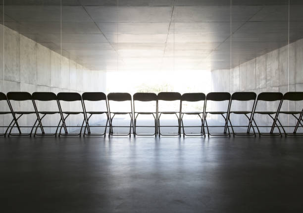 istock Silhouette of office chairs lined up in a row 468837909