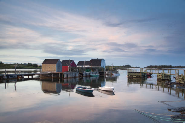 istock Rowboats and buildings on calm bay 468838183