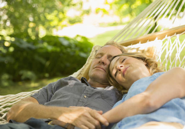 Couple sleeping in hammock  hammock relaxation women front or back yard stock pictures, royalty-free photos & images