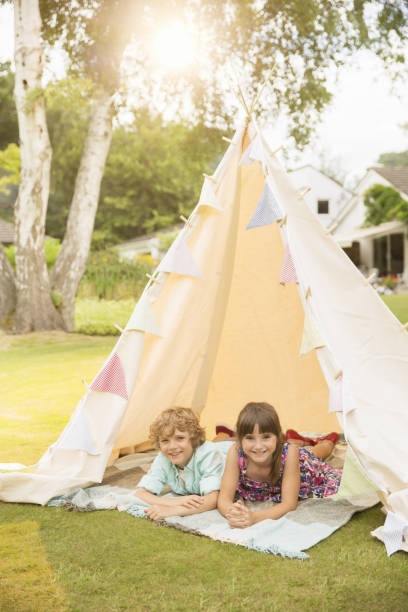 istock Children laying in teepee in backyard 468838495