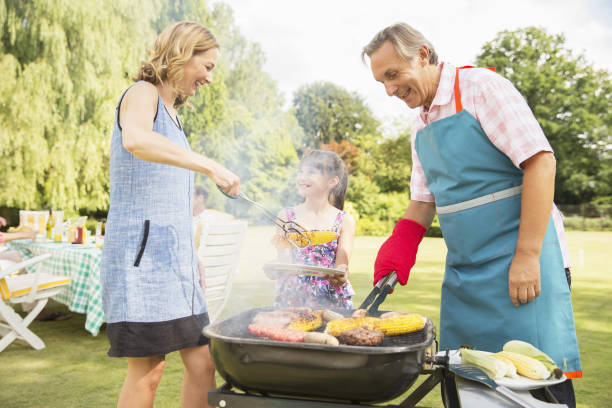 istock Multi-generation family standing at barbecue in backyard 468838505