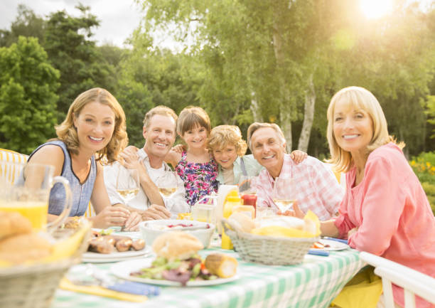 istock Multi-generation family enjoying lunch at table in backyard 468838541
