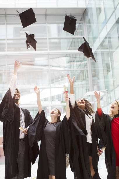 istock Graduates tossing caps in air 468838769