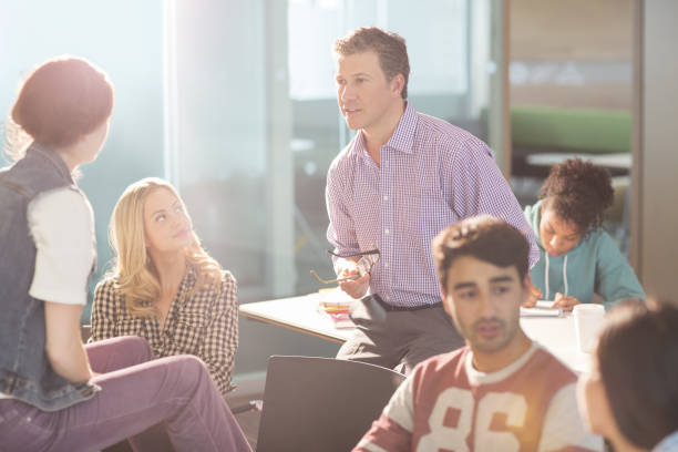 istock Professor and university students talking in classroom 468838841