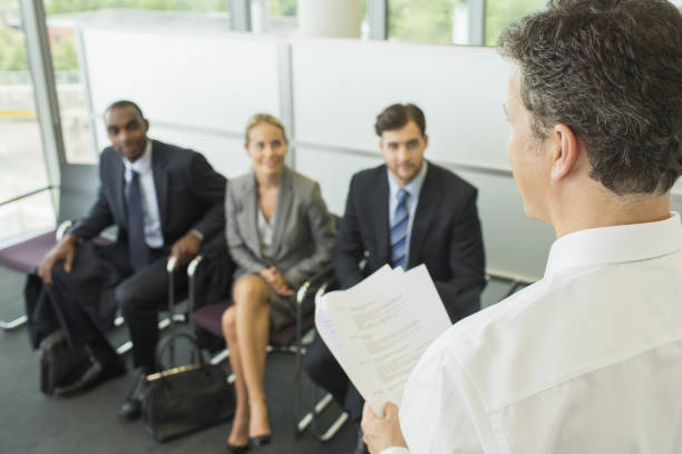istock Businessman talking to colleagues in office 468839345