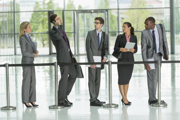 istock Businessman talking on cell phone in line 468839399