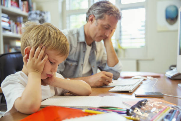 Father and son working in home office  colouring stock pictures, royalty-free photos & images