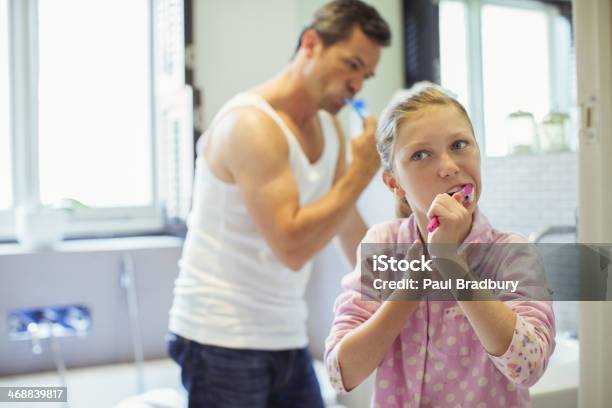 Father And Daughter Brushing Teeth In Bathroom Stock Photo - Download Image Now - 10-11 Years, 40-44 Years, Adult