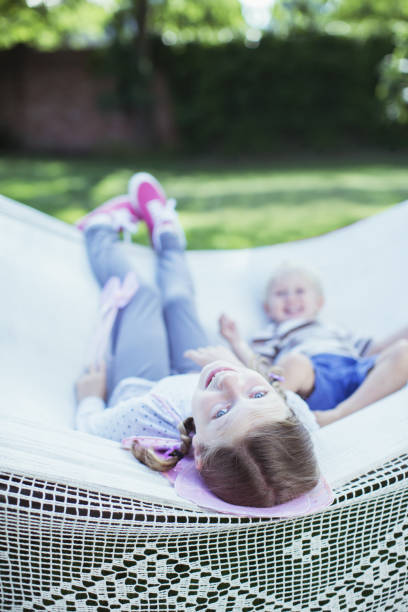istock Children relaxing in hammock outdoors 468840017