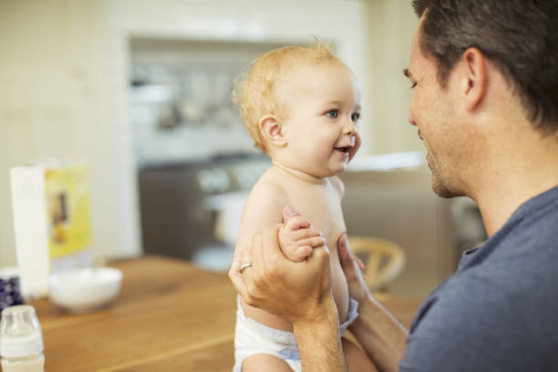 istock Father holding baby in kitchen 468840029