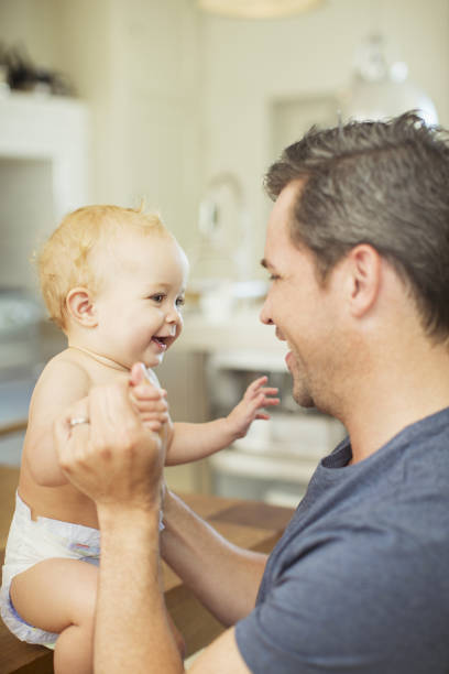 istock Father and baby laughing in kitchen 468840051