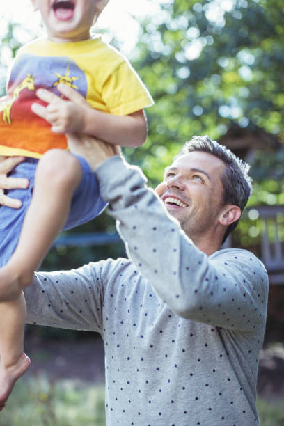 istock Father playing with son outdoors 468840149