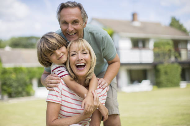 istock Grandparents and grandson hugging in backyard 468840217