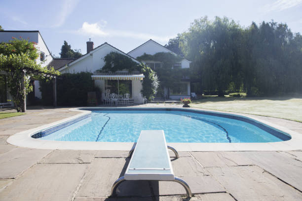 Diving board at the edge of swimming pool  diving board stock pictures, royalty-free photos & images