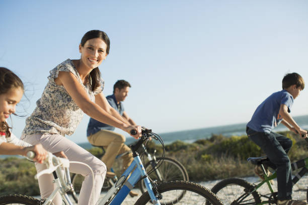 istock Family riding bicycles on beach 468840447