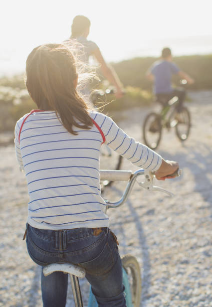 istock Family riding bicycles on sunny beach 468840461
