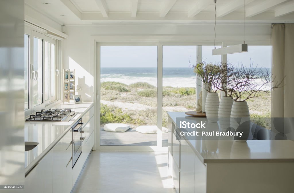 Modern white kitchen with ocean view  Home Interior Stock Photo