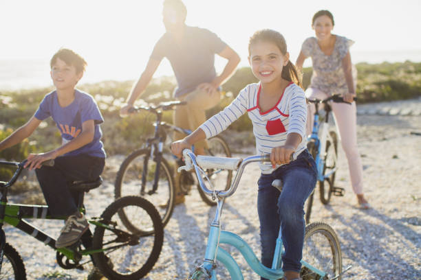 istock Family riding bicycles on sunny beach 468840583