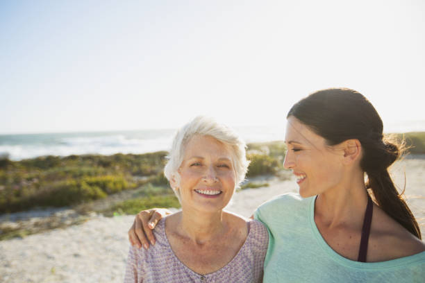istock Mother and daughter on sunny beach 468840595