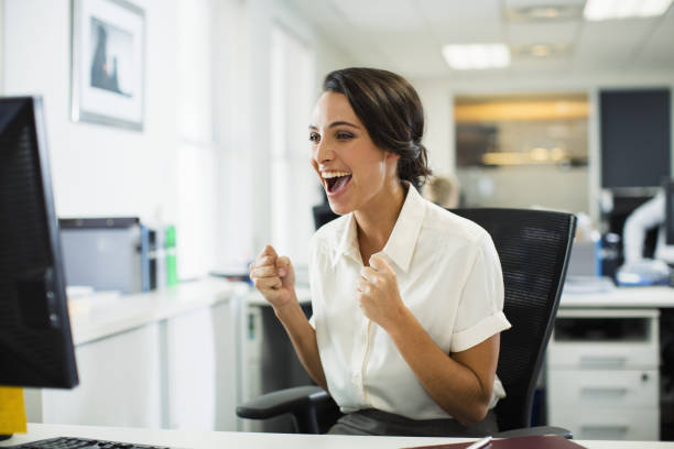 istock Businesswoman cheering in office 468840999