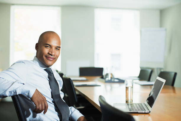 istock Businessman smiling at conference table 468841055