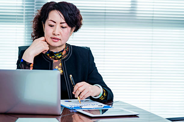 istock senior businesswoman writing in office 468841492