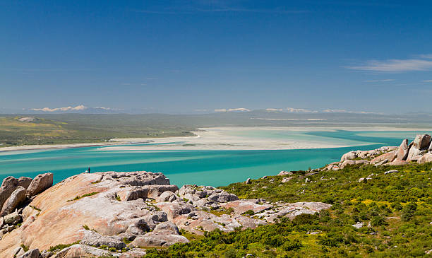 Turquoise waters of the Langebaan Lagoon The snow-capped Cederberg mountains and turquoise waters of the Langebaan Lagoon. West Coast National Park, South Africa cederberg mountains photos stock pictures, royalty-free photos & images